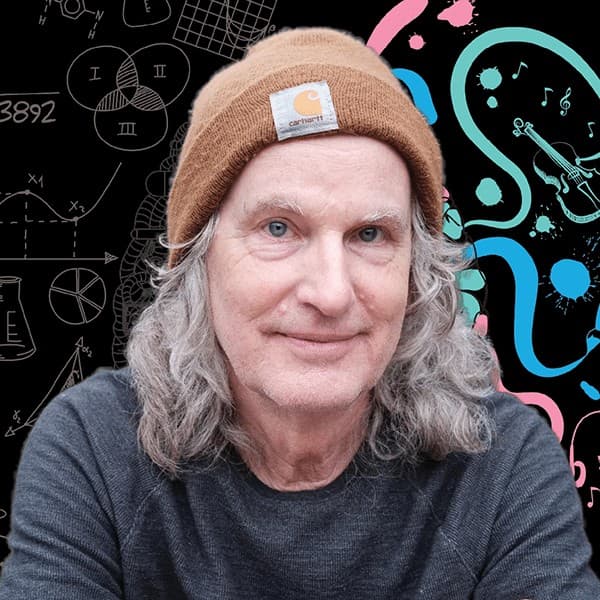 Portrait of Steve Rucker in a tan knit beanie, smiling